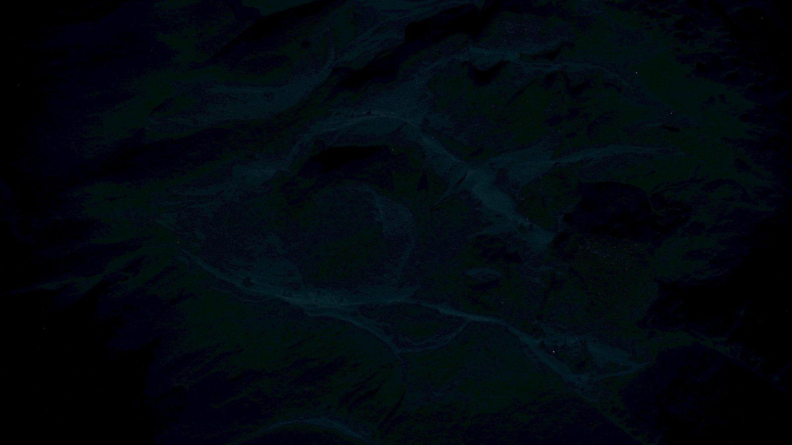 This image is very dark with indistinct patterns or textures, possibly resembling an abstract or aerial view.