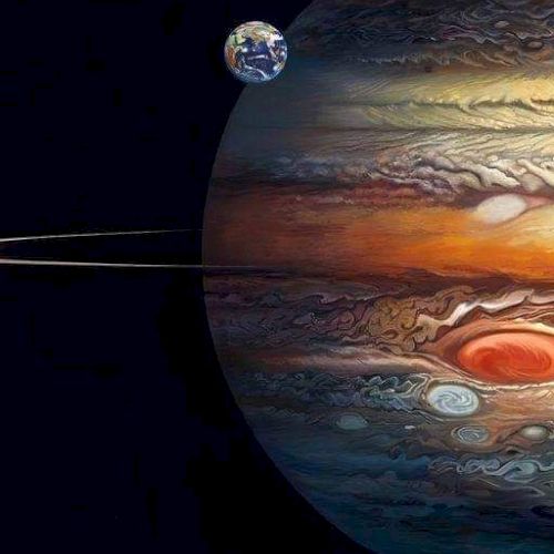 The image shows a digitally created scene with Jupiter, its Great Red Spot, its rings, and a small Earth in the background.